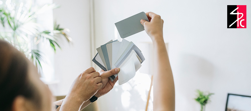 Person using color cards to plan a painting project