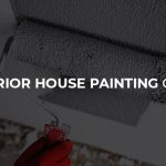 Exterior painting contractor using a roller paint brush