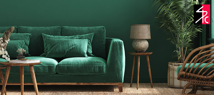 A living room with a green painted wall and matching green furniture